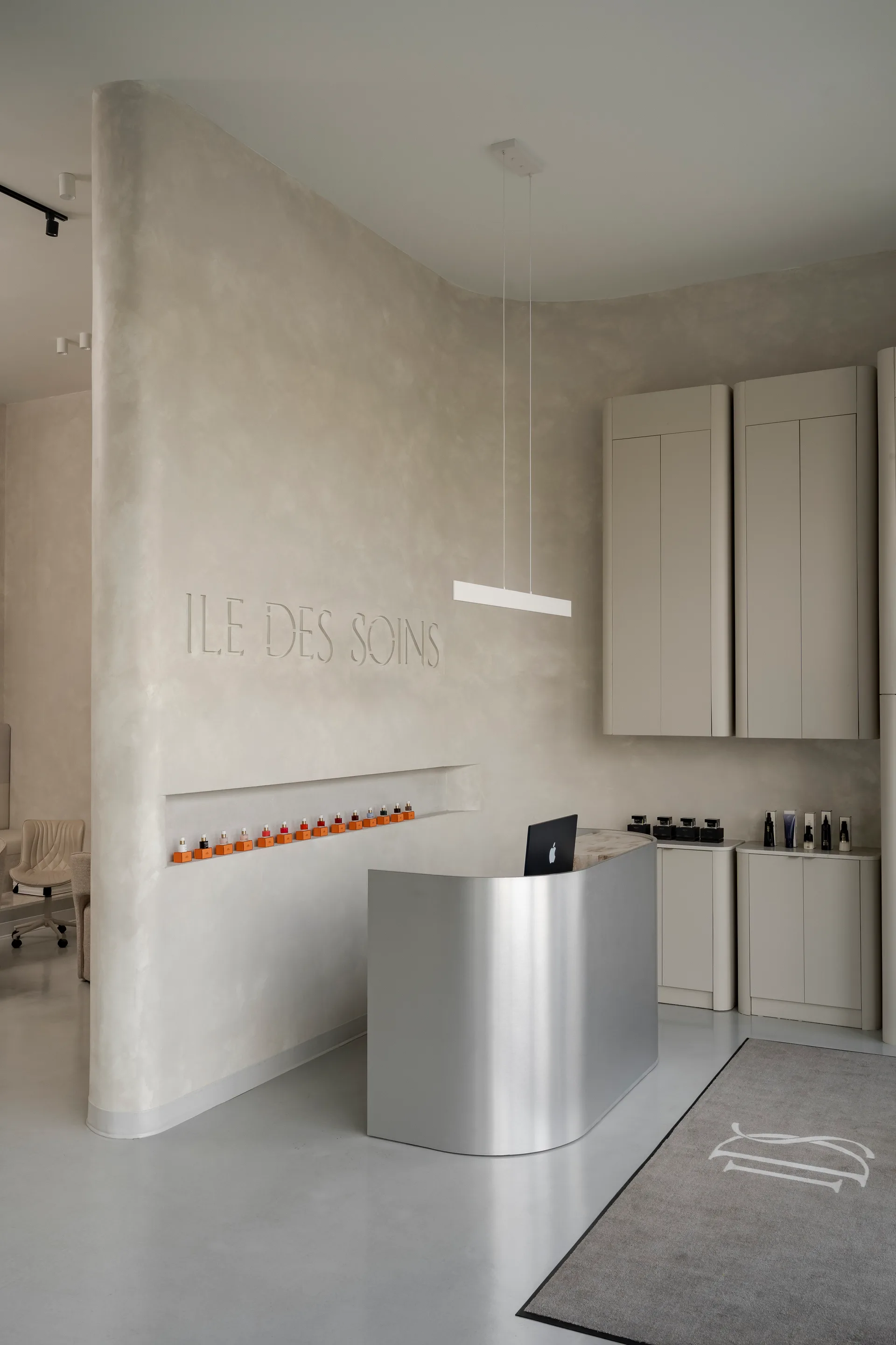 Reception area with metal desk and product bottles