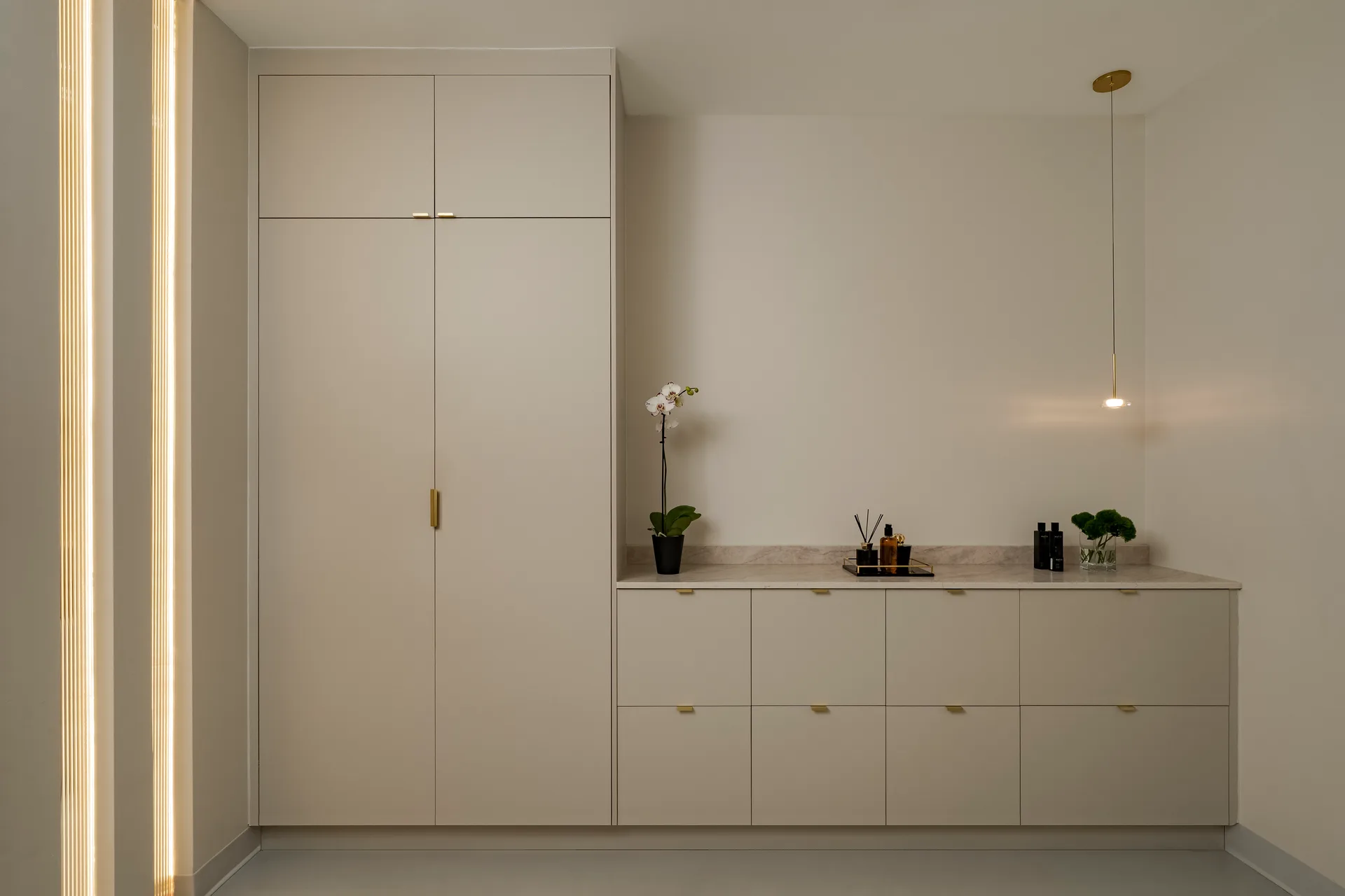 Pale cabinetry with flowers on the counter