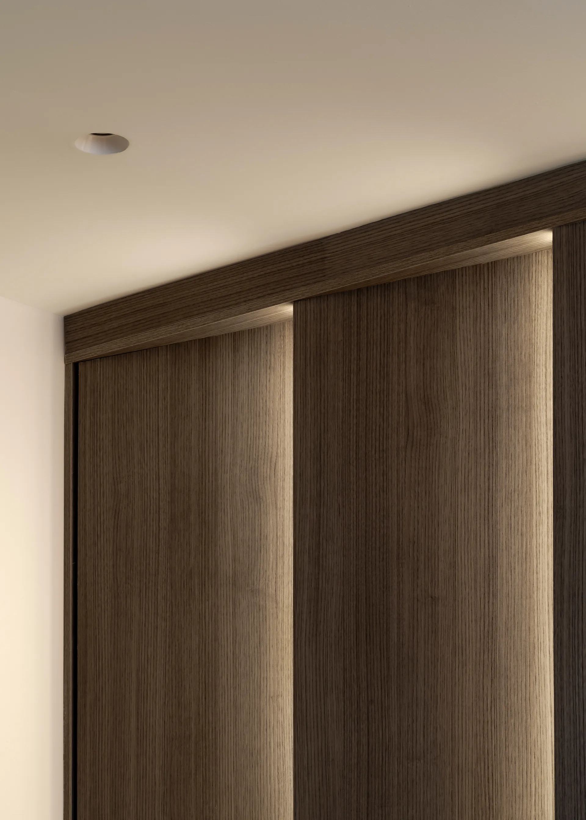 Upper detail of timber panelling and ceiling