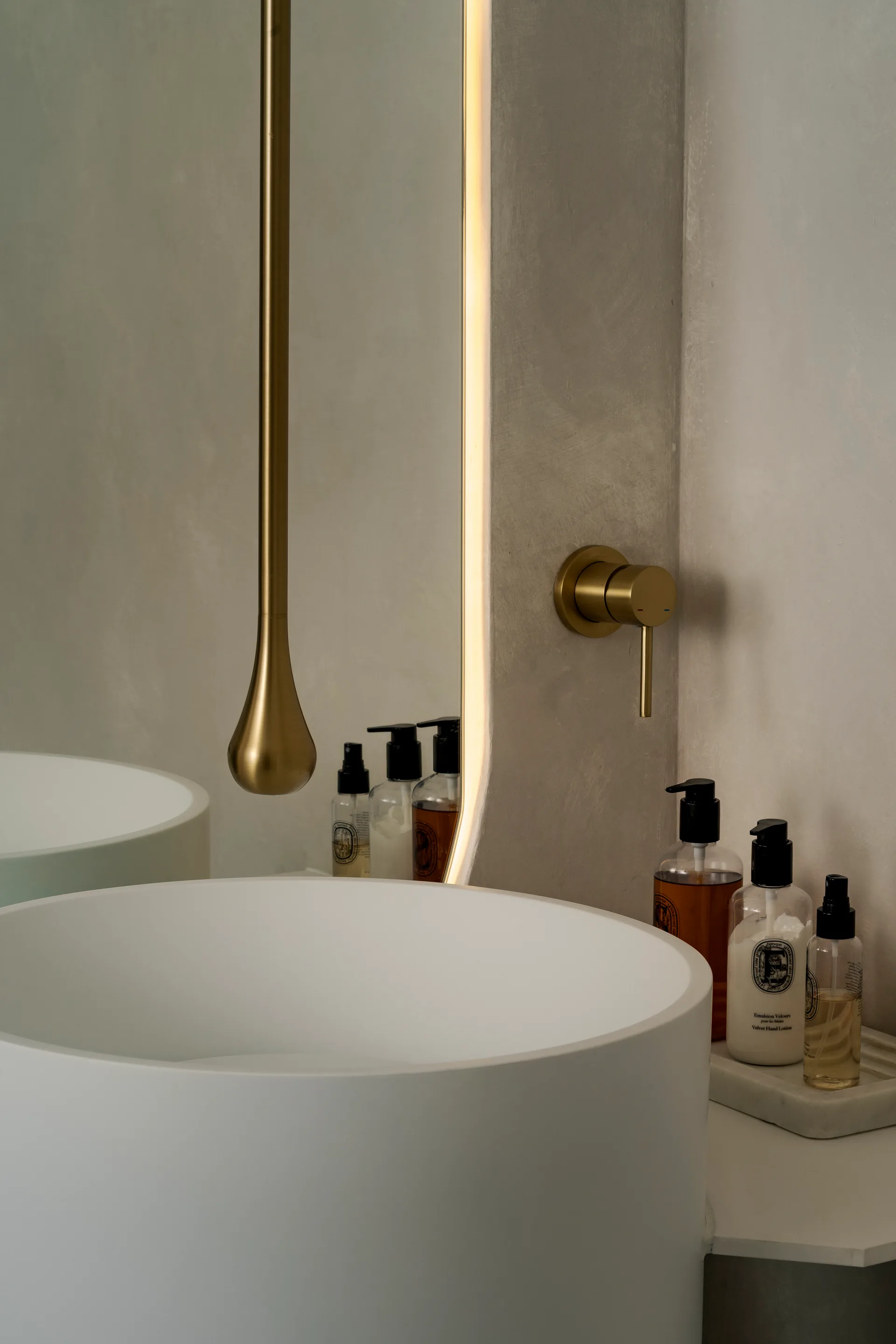 White washbasin with brass fittings