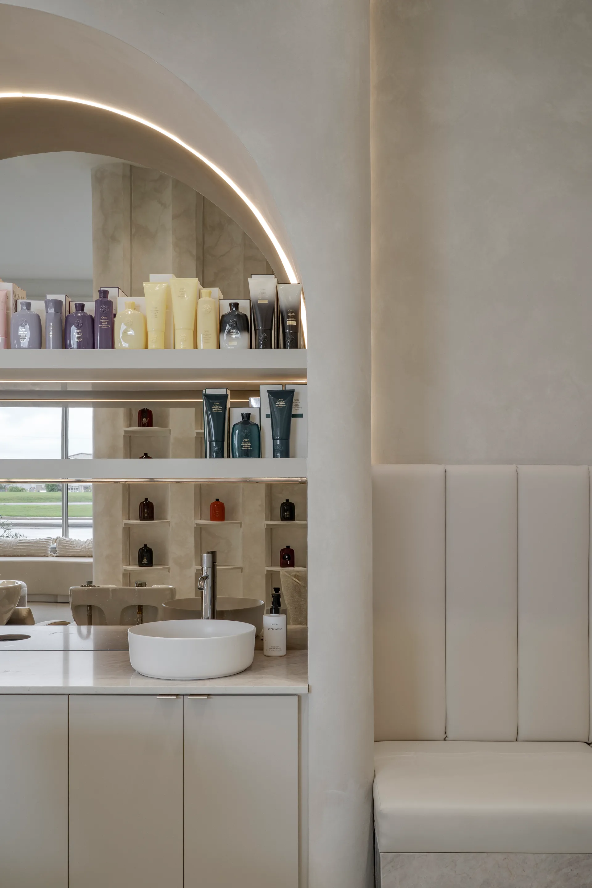Arched product display with pale shelving