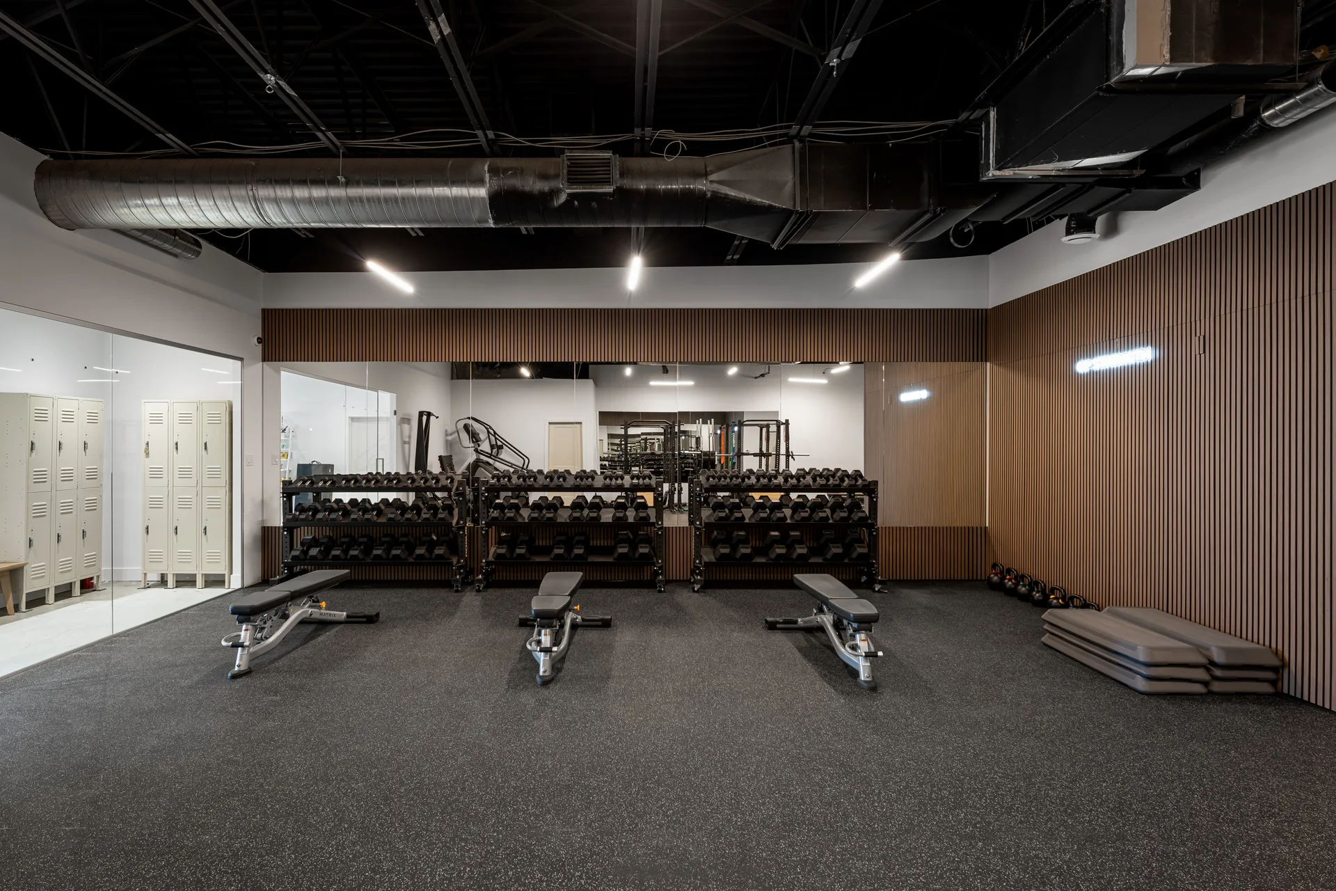 Training studio with exercise equipment and timber wall