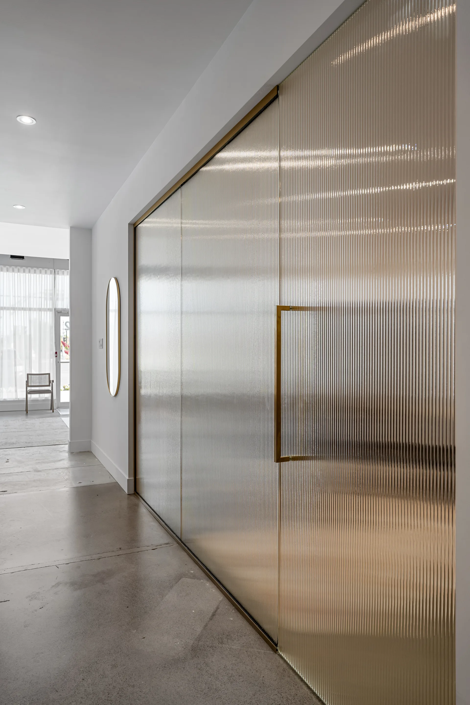 Glazed timber partition along a corridor