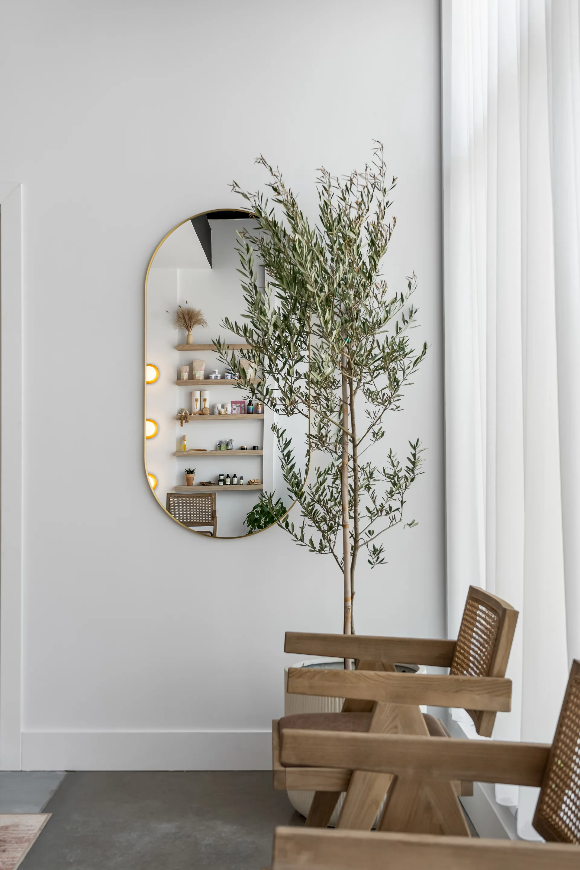 Timber seating beside a mirror and flowers